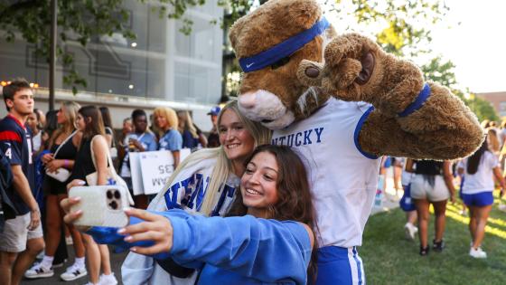 Photo of two students taking a selfie with the Wildcat mascot