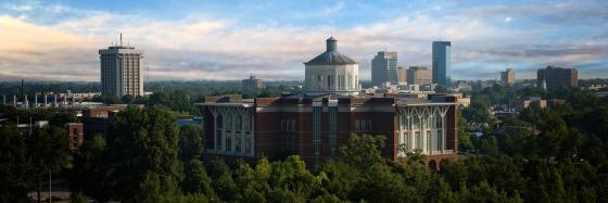 Campus buildings peek through tree tops
